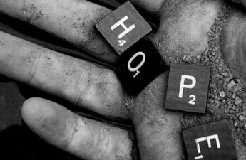 Hand holding the word "Hope"